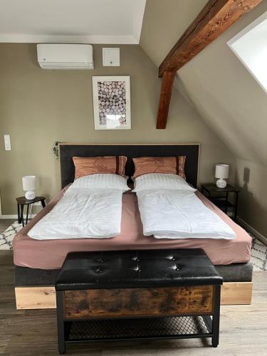 a bedroom with a large bed with a wooden frame at „Holzwurm-Paradies“ in Ivenack