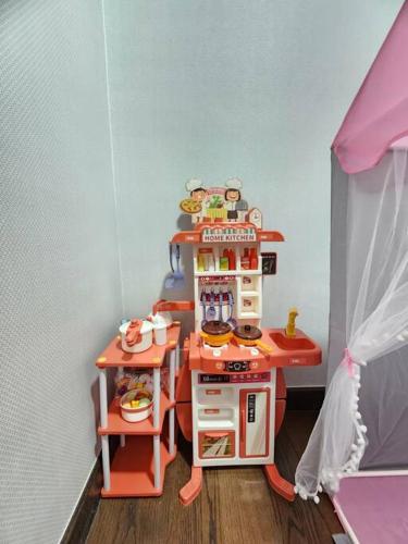 a doll house with a pretend kitchen in a room at 2-6Pax Luxury Almas Duplex Suite Legoland near JB & Tuas in Nusajaya