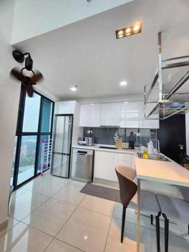 a kitchen with white cabinets and a ceiling fan at 2-6Pax Luxury Almas Duplex Suite Legoland near JB & Tuas in Nusajaya