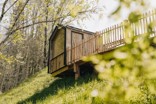 a tree house on a hill in the woods at Salzbergalm in Berchtesgaden