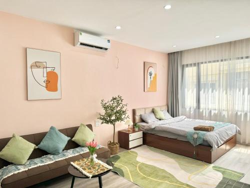 a living room with a bed and a couch at The Little Home - Cù Chính Lan - Modern & Comfy Apartment in Hanoi