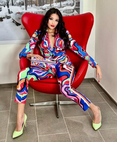 a woman is sitting in a red chair at Piccolo Feudo Green Resort in Viterbo