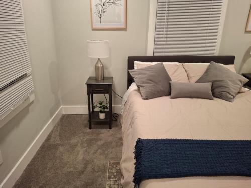 a bedroom with a bed with a lamp on a table at Luxury 4 Large Bedrooms with 5 Beds and 3 Baths, a Quiet Street in Cascade Area in Atlanta