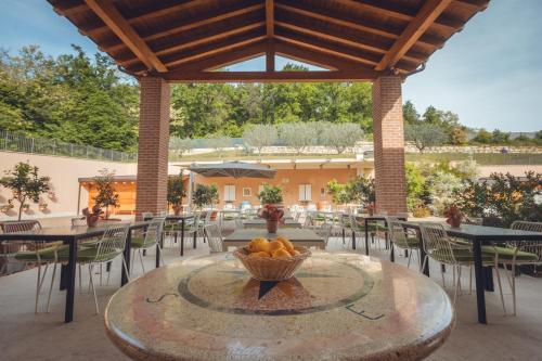 a table with a bowl of fruit on a patio at Agriturismo La Pertica in Costermano sul Garda
