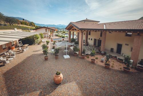 an outdoor patio with potted plants and a building at Agriturismo La Pertica in Costermano sul Garda