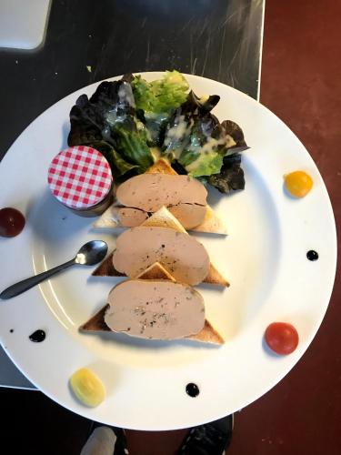 a plate of food on a table with food at Hôtel de la Loube in La Roquebrussanne