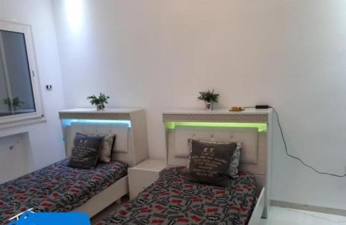 a bedroom with two beds and two plants on top at Corner of Paradise 4 bedrooms with private pool Yasmine Hammamet in Hammamet