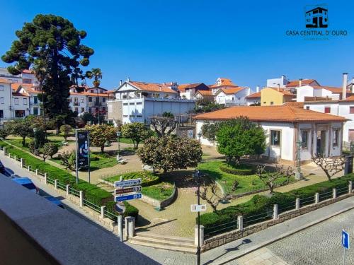 a park in the middle of a city with buildings at Casa Central D'ouro in Tabuaço