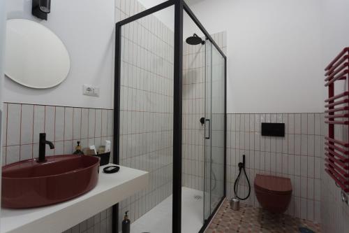 a bathroom with a sink and a glass shower at Navona 68 in Rome