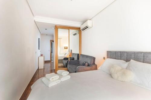 een slaapkamer met een wit bed en een woonkamer bij Apartamento en Madrid Centro in Madrid