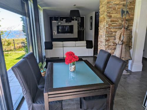 a living room with a glass table and chairs at La Mar de Bonita in Tagle