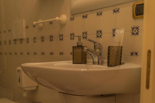 a bathroom with a sink and a toilet at Villa Caramia in Locorotondo