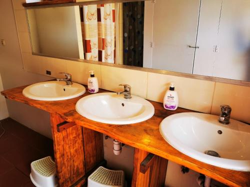 a bathroom with two sinks and a mirror at Glamping Kaliska in Łochów