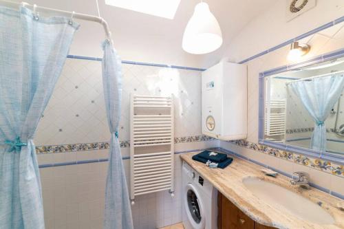 a bathroom with a sink and a washing machine at Casa Stella di mare in Positano