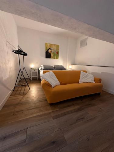 a living room with a yellow couch and a bed at Libeccio 1 - Holiday Home Lerici in Lerici