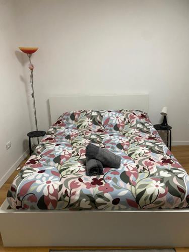 a bedroom with a bed with a flower patterned bedspread at Allen easyLoft in Trieste