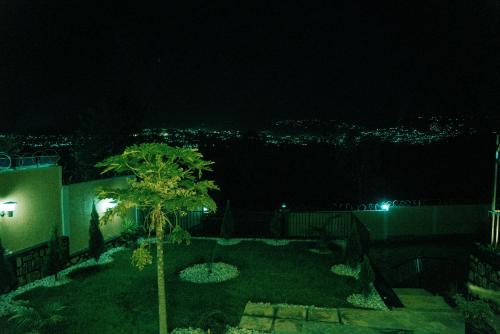 a view of a yard at night at Furnished House at Kibagabaga in Kigali