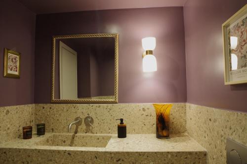 a bathroom with a sink and a mirror at Absolute Athens Acropolis View in Athens