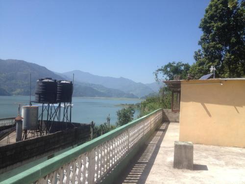 a view of a lake with a watermill on a wall at Peace Guest House in Pokhara