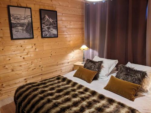 a bedroom with a large bed with two pillows at Spacieux T3 terrasse en rez coeur de station in Bernex