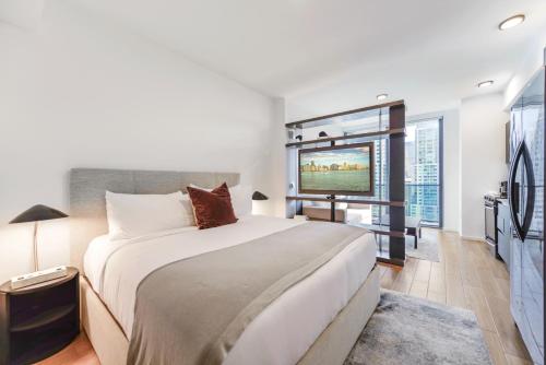 a bedroom with a large bed and a large window at Incredible High-Floor Studio with Bay Views in Miami