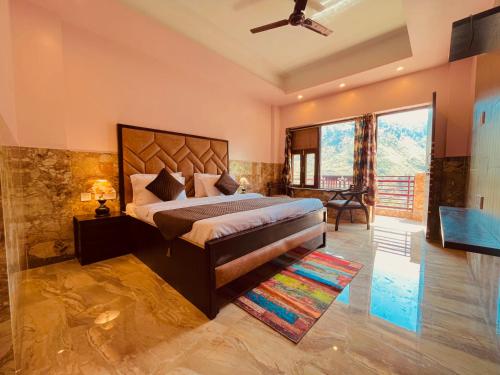a bedroom with a king sized bed and a table at Samantha Guest House in Bhavnagar