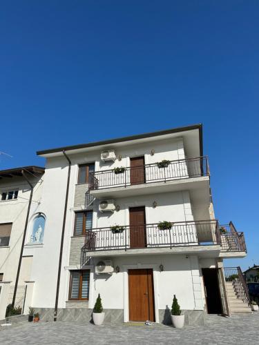 a white building with two balconies on it at Damiani B&B 