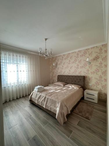 a bedroom with a large bed and a chandelier at Damiani B&B 