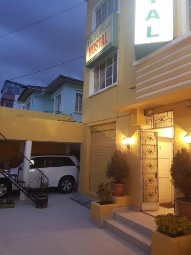 a hotel with a car parked outside of it at Petite Maison in Quito