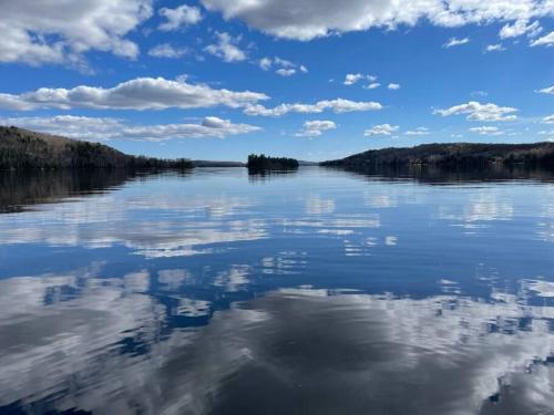 a view of a lake with clouds in the sky at Le Petit Domaine Caché - Lac-Simon in Lac-Simon
