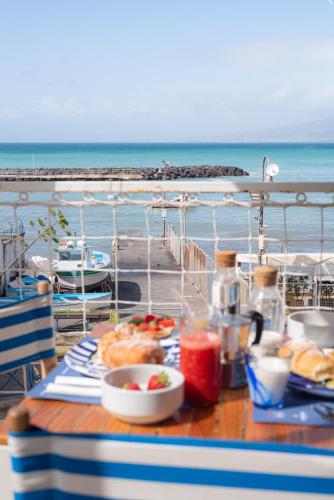 a table with food and drinks on a cruise ship at Lampara Mare in Vico Equense