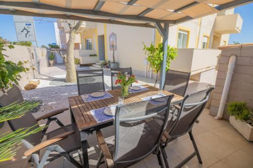 a wooden table and chairs on a patio at B&B Dona Ana in Lagos