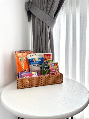 a basket of snacks sitting on top of a table at Moon Homestay in Thôn Kim Long (1)