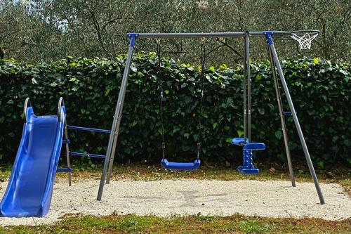 a playground with two swings and a basketball hoop at Apartment GIDAS in Zadar