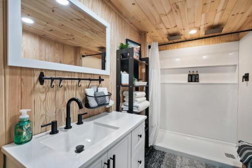 a bathroom with a white sink and a shower at Bear Whispers in Townsend