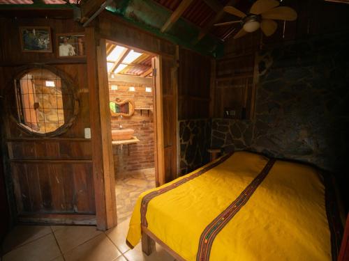 a bedroom with a bed in a room with a window at 1 bedroom cabin, 3 blocks from beach and center of San Juan in San Juan del Sur