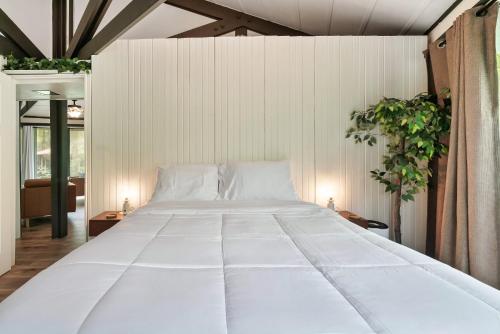 a bedroom with a large white bed in it at Bear Whispers in Townsend