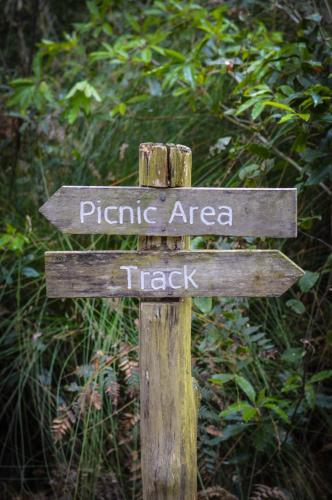 a wooden sign that says picnic area and track at Ghost Hill Road Retreat in Bilpin