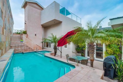 a house with a swimming pool and palm trees at Ocean & Bay Views Pool & Hot Tub Rooftop Patio in San Diego
