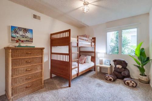 a bedroom with a bunk bed and a teddy bear at Ocean & Bay Views Pool & Hot Tub Rooftop Patio in San Diego