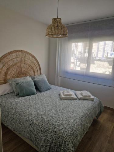 a bedroom with a bed with two towels on it at Apartamento Mouro in Santander