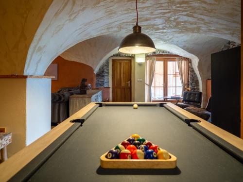 a pool table in the middle of a living room at Chalet le Villarais1 sauna billard in Villard-Reculas