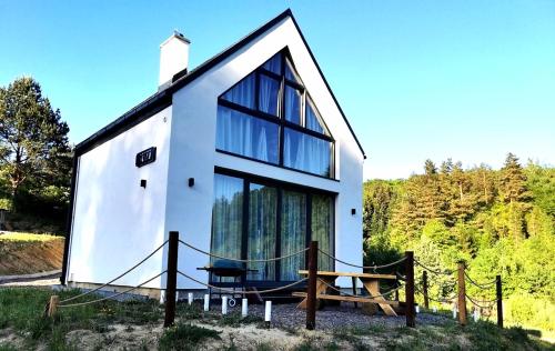 a house with a large window on the side of it at MotoChillout in Polańczyk