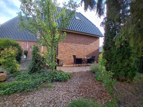 a house with a table and a tree in the yard at Bed & Breakfast in ons Bakhuis in Apeldoorn