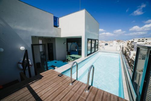 a house with a swimming pool on a balcony at Eleven by Warren Collection in Sliema