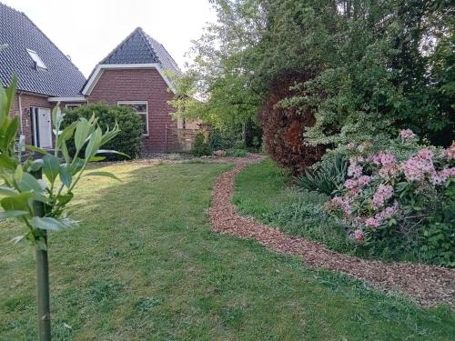 a yard of a house with a dirt road at Bed & Breakfast in ons Bakhuis in Apeldoorn