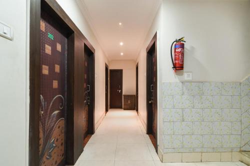 a hallway with two doors and a tile floor at OYO Flagship Hotel Sai Krishna in Khandagiri