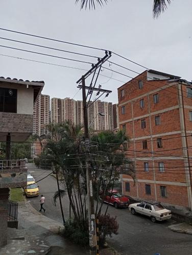 a street with cars parked on the side of a city at Habitación # 1 Moderna y Cómoda in Bello