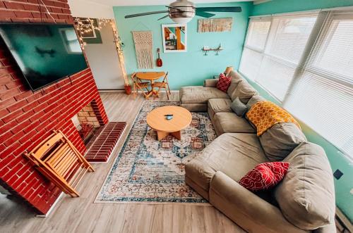 a living room with a couch and a table at Sweet Sunny Summit House in Greensboro