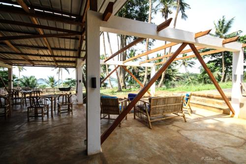 a pavilion with tables and chairs and a table and chairsktop at Sonho Non in Santana